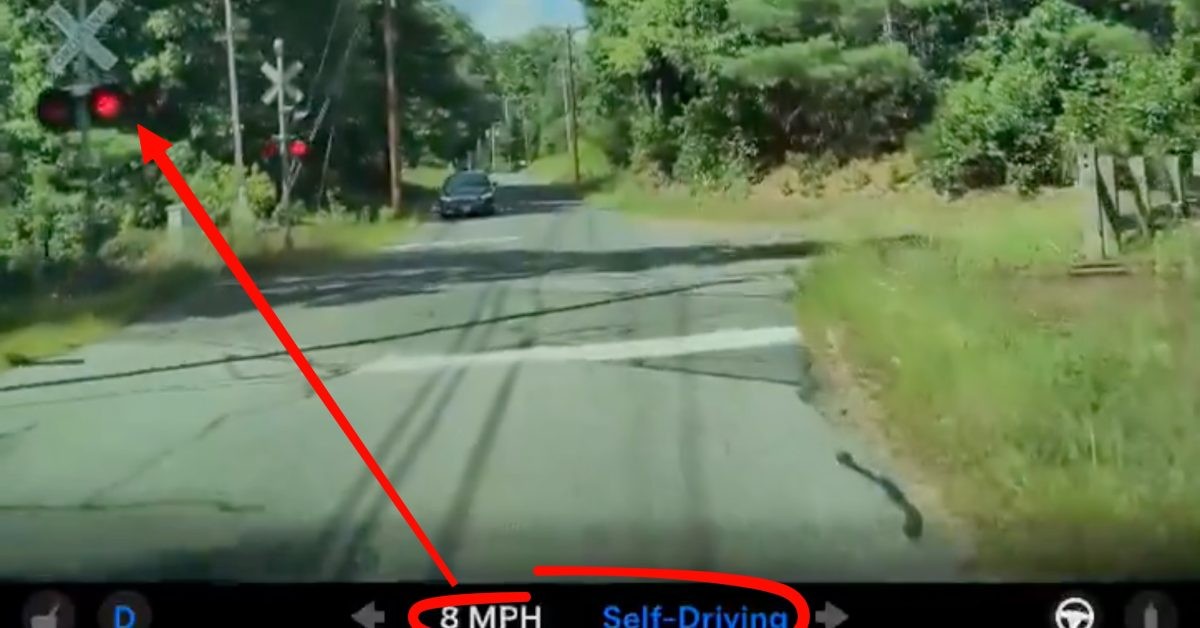 Tesla FSD narrowly avoids collision with a passing train at crossing